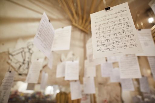 A closeup of sheets of music notes hanging from the ceiling