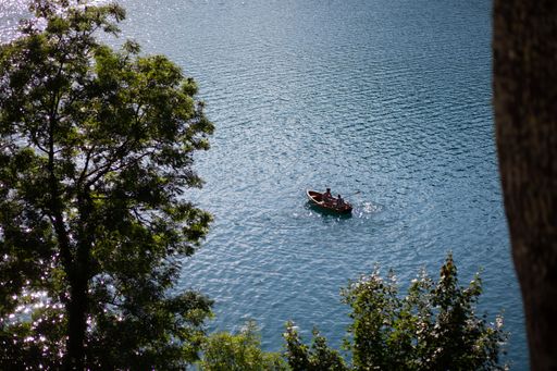 A high angle shot of a boat in the Lake Bled in Slovenia