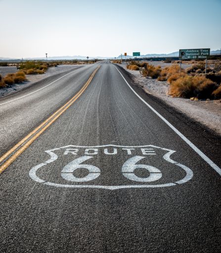 A vertical shot of the US Route 66 on a sunny day in the Mojave Desert, Nevada