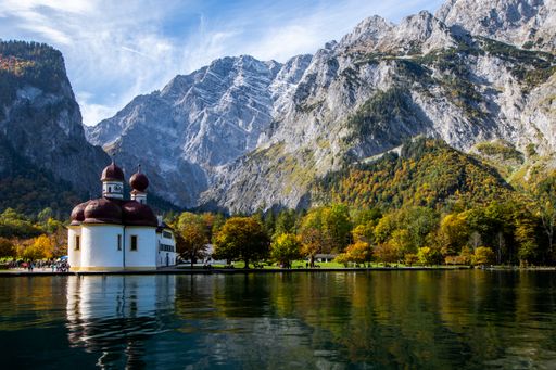 The St Bartholomew's Church surrounded by the Koenigssee and rocky mountains in Bavaria, Germany