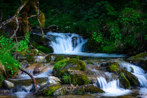 A waterfall with long exposure in a forest in Schliersee, Bavaria, Germany