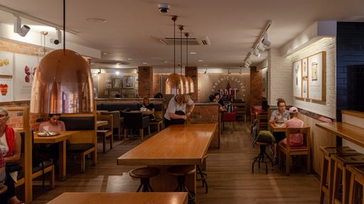 A cozy coffee shop with customers in Paris, France