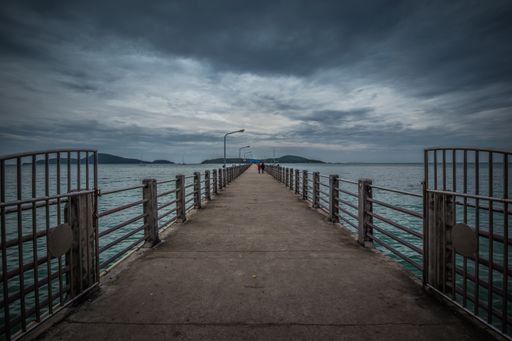 A beautiful shot of a pier on a sea under the cloudy skies in Rawai Beach, Phuket