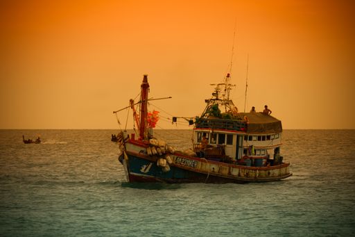 A beautiful shot of a fishing boat at Rawai Ba under the cloudy skies in Thailand