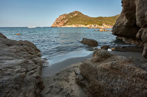 Wiew frof low perspective of Exit to a natural cave on the beach of Cala Sa Figu in the south of Sardinia near Cagliari during the summer.