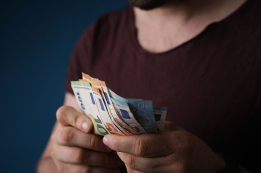 The European Euro bills in the hands of a man counting