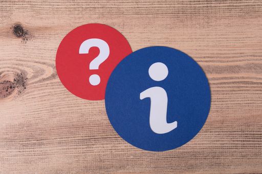 The round information and question signs and a wooden floor on the background
