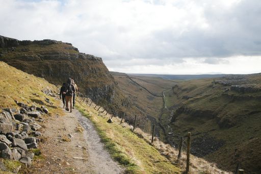 Yorkshire Dales National Park in Winter, people on a trail, England, UK