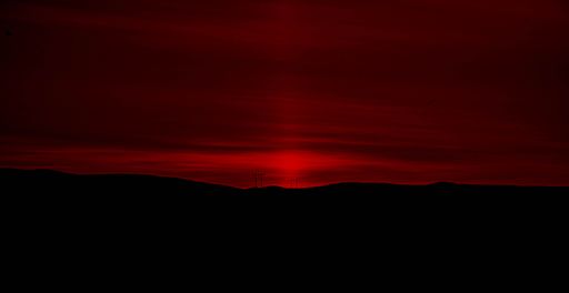 A beautiful view of a landscape under the red sunset sky