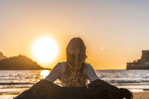 A beautiful young Colombian blonde on the beach at sunset in San Sebastian, Spain