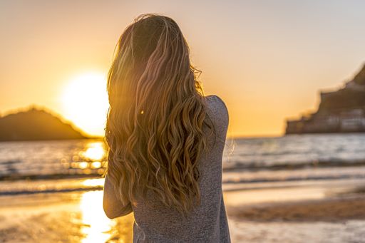 A beautiful young Colombian blonde on the beach at sunset in San Sebastian, Spain