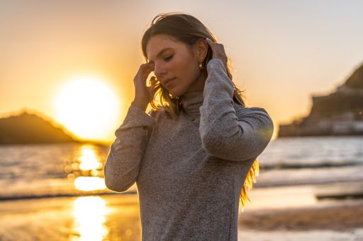 A beautiful young Colombian blonde posing at the beach at sunset in San Sebastian, Spain