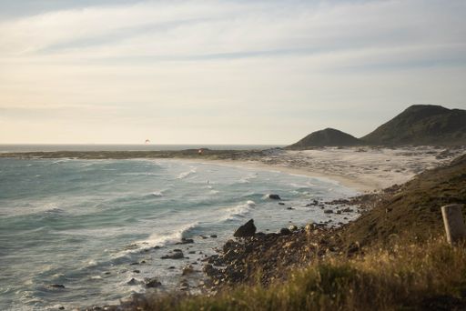 A beautiful view of the wavy South Atlantic Ocean hitting the sandy beach on the coast in Witsand