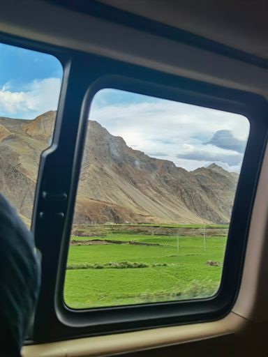 A vertical shot of a beauiful mountainous landscape captured from a car window