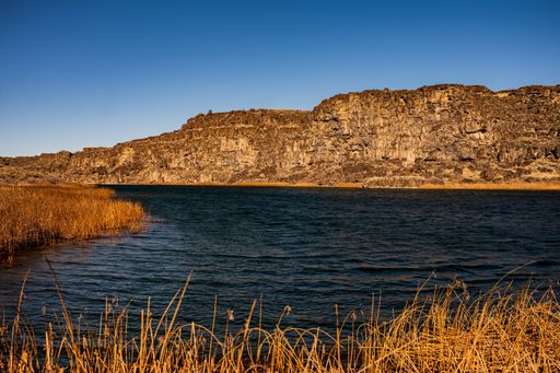 A view of a lake and mountains under the blue sky