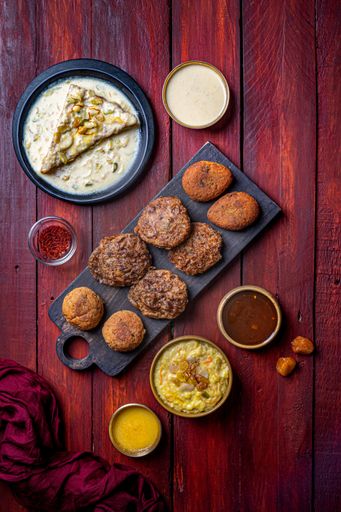 a vertical shot of Tunde ke kabab Indian dish with sauces