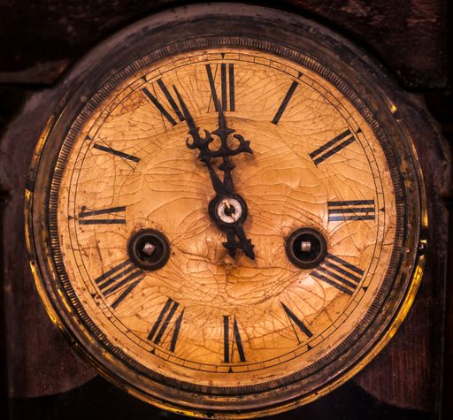 A closeup shot of an old vintage wooden clock