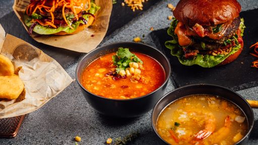 A closeup shot of hamburgers and soups