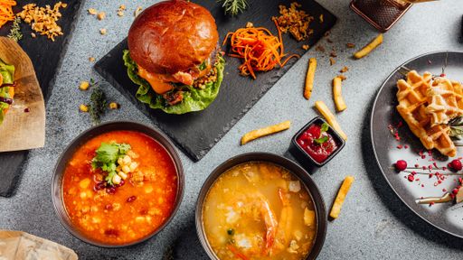 A top view of various food types soups, hamburgers, and other ingredients