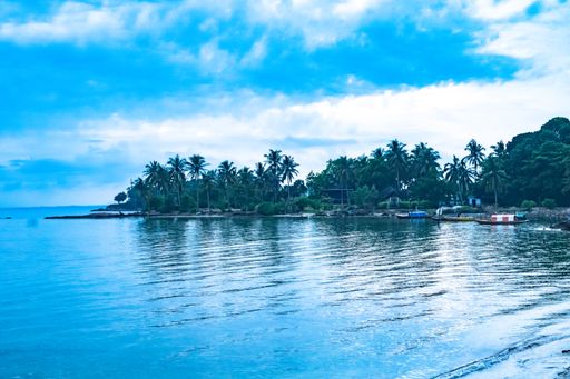 A mesmerizing scene of the magic blue water in the Islands in Batam, Indonesia against a cloudy sky