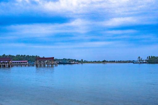 A mesmerizing scene of the magic blue water in the Islands in Batam, Indonesia against a cloudy sky