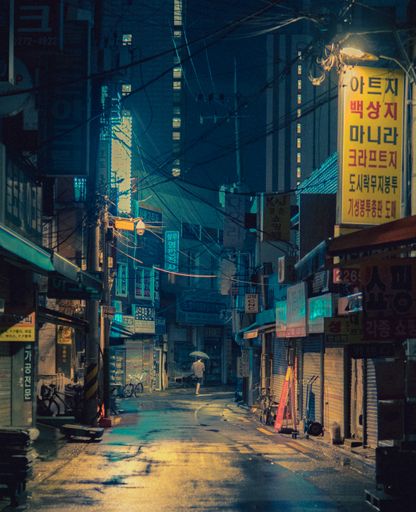 A vertical shot of a lonely stranger in the streets of Seoul on a rainy night