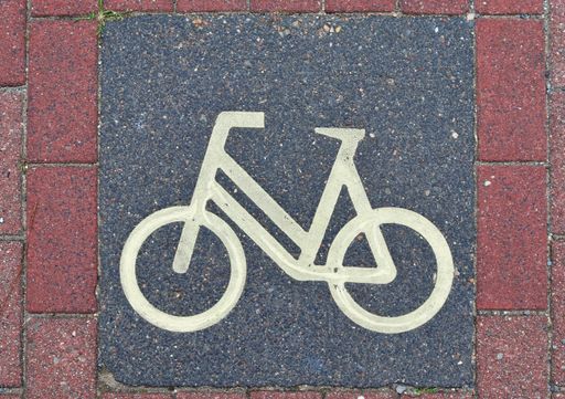 A high angle shot of a bicycle sign painted on the ground