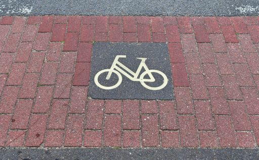 A high angle shot of a bicycle sign painted on the ground