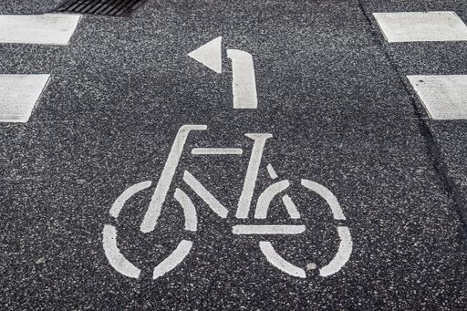A bicycle lane with an arrow which shows the direction painted on the ground