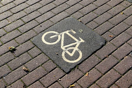 A high angle shot of a bicycle sign painted on the ground