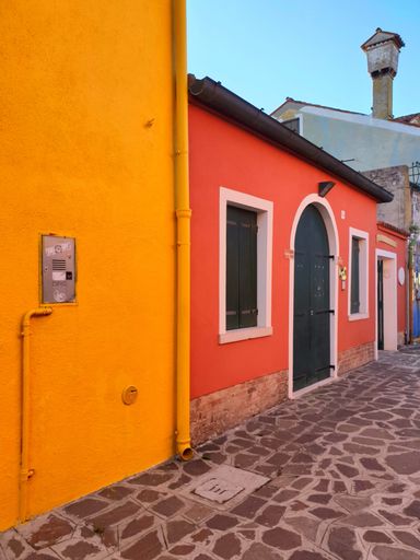 A low-angle shot of colorful painted houses on Burano island, Venice, Italy