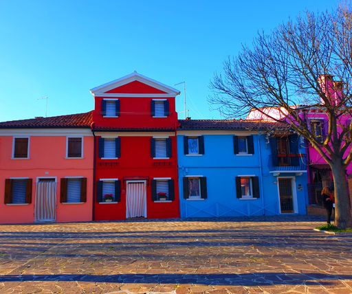 A low-angle shot of colorful painted houses on Burano island, Venice, Italy