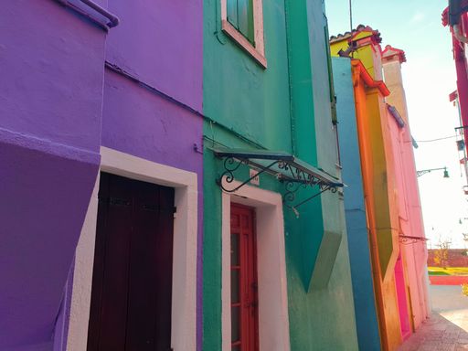 A low-angle shot of colorful painted houses on Burano island, Venice, Italy