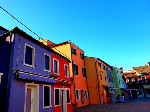 A low-angle shot of colorful painted houses on Burano island, Venice, Italy
