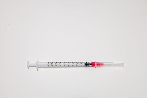 A top view of a medical syringe for medicine on a white background