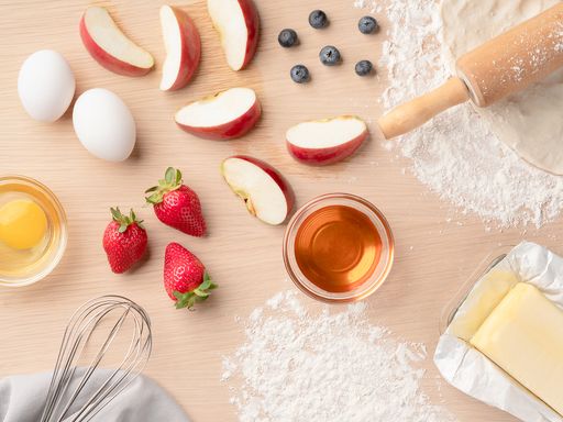 A top view of ingredients on a wooden table for baking a pie
