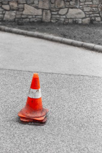 A vertical shot of traffic cones on a street