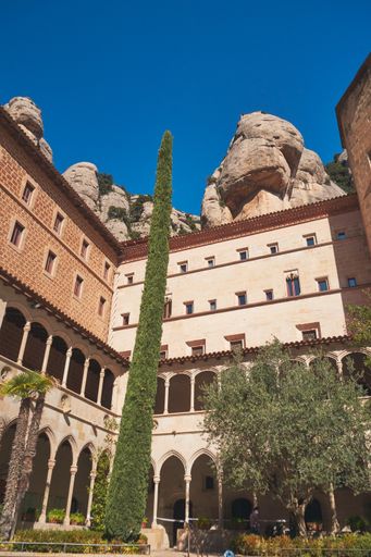 A vertical shot of the Abbey of Montserrat building in Barcelona, Spain against a blue sky