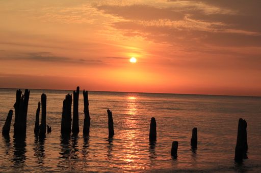 A beautiful view of a sunset at lake Michigan with stone columns