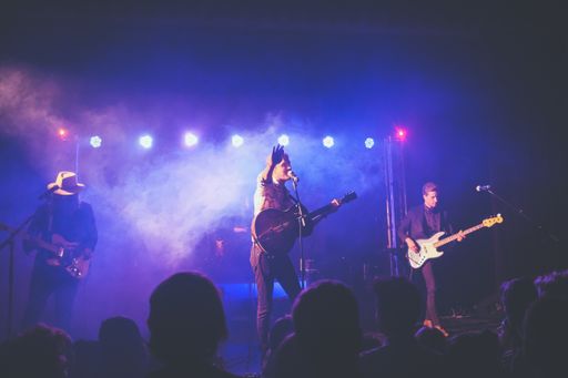 Rack band on stage playing live.