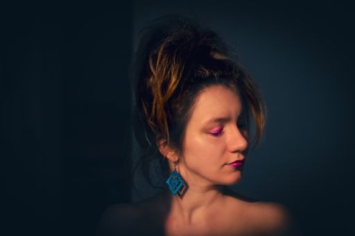 A beautiful Caucasian woman with her eyes closed under sunlight