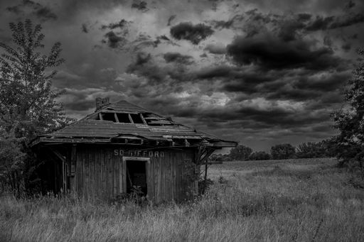 A grayscale of an abandoned building