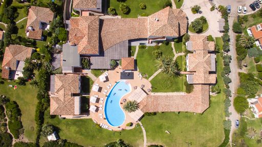 View of some houses with a pool in Costa Rei in southern Sardinia taken from above with a drone
