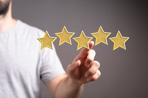 A male pointing at five-star symbols to increase the rating of the company
