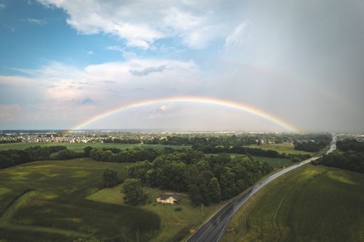 A view of a colorful rainbow over scenic countrys