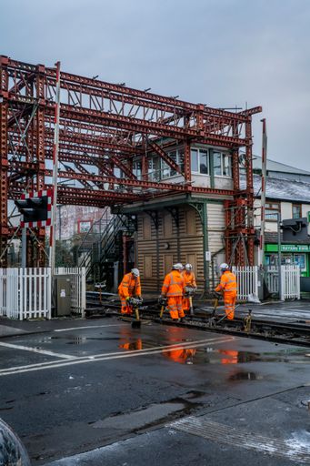 A vertical shot of railway workers working on a level crossing in Bamber Bridge, Preston