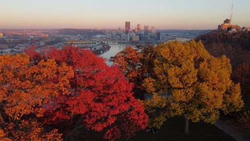 A beautiful view of a cityscape surrounded by colorful autumn trees in Pittsburgh, Pennsylvania