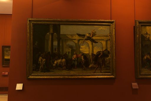 A painting hanging on the red wall of the Louvre museum, Paris, France