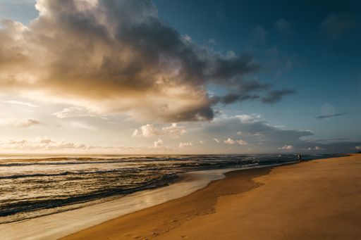 A beautiful view of a sandy beach during sunset