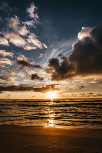 A vertical shot of a beautiful ocean during sunset